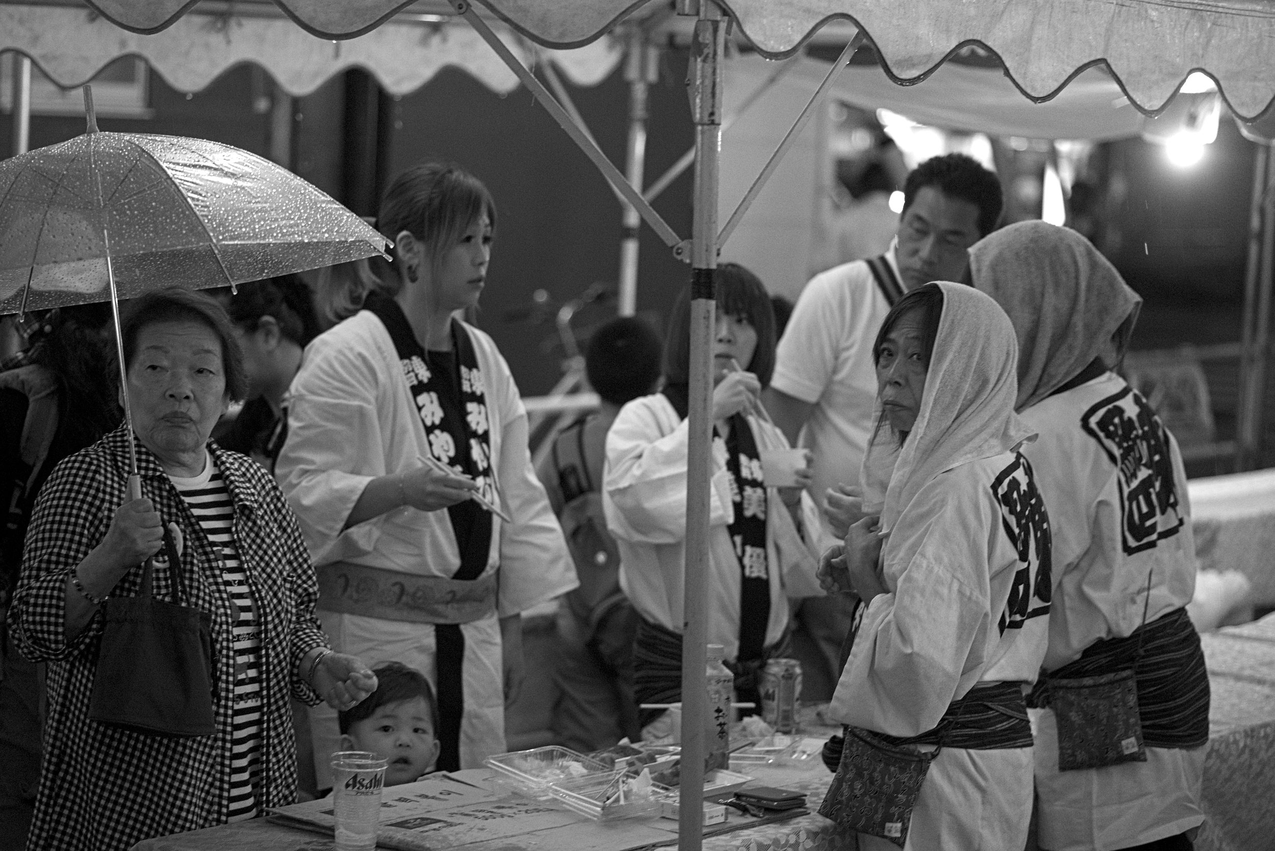 People enjoying snacks and beer under umbrellas