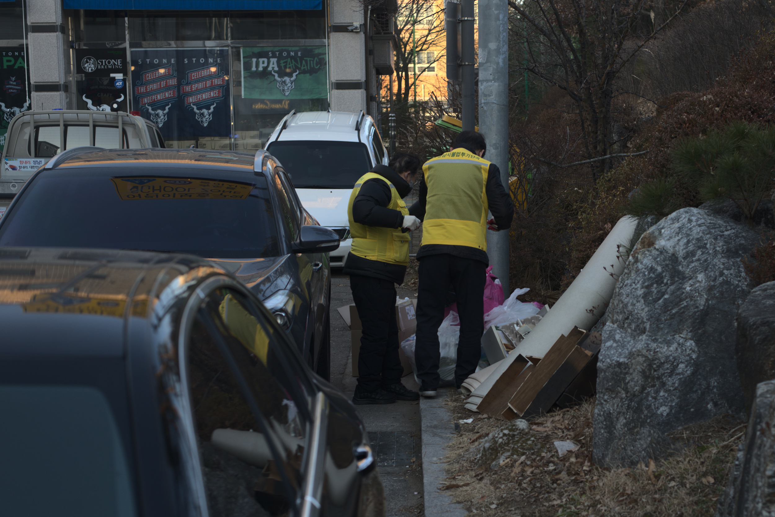 Two man going through trash