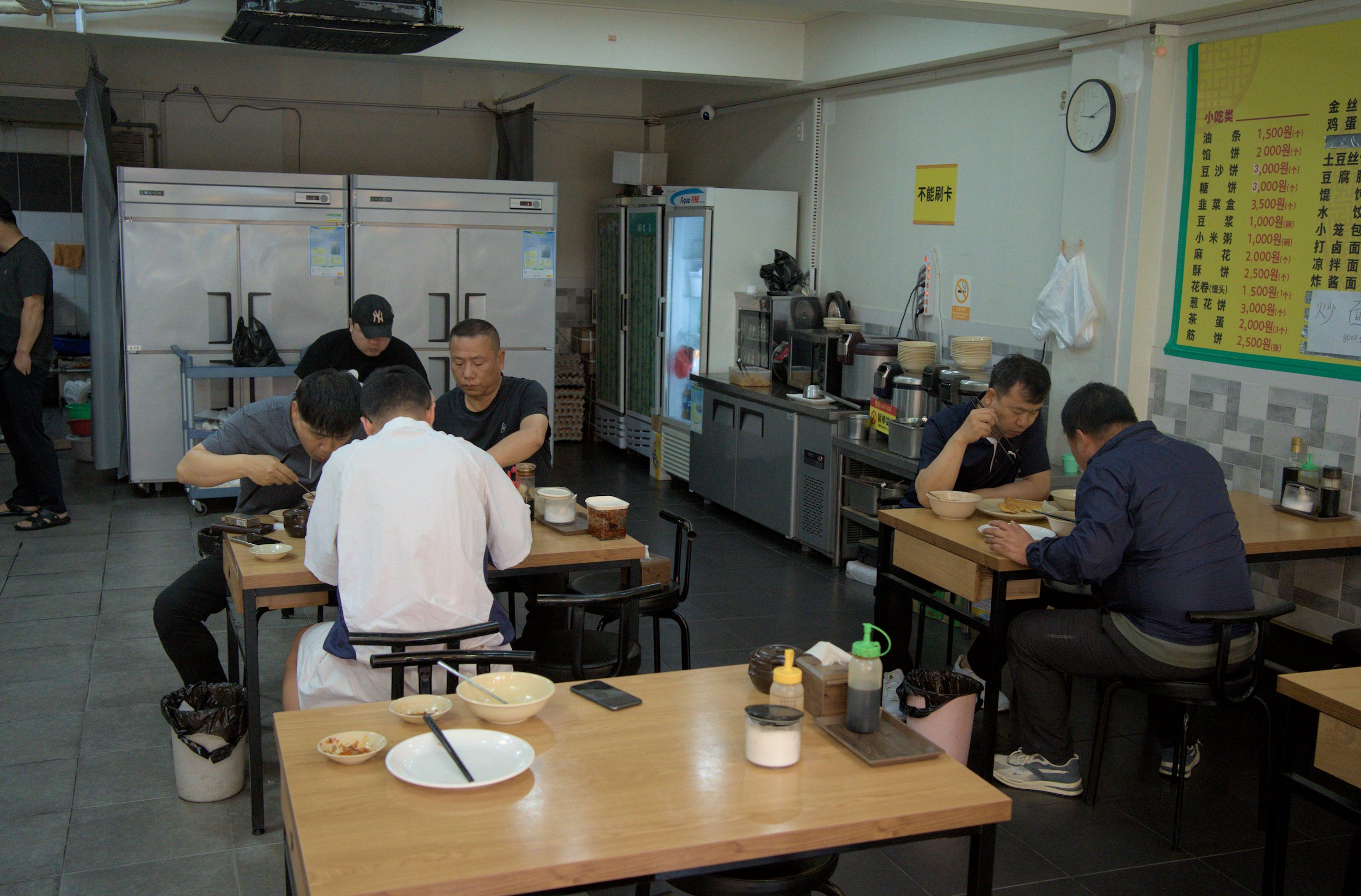 Men in a Chinese restaurant eating breakfast
